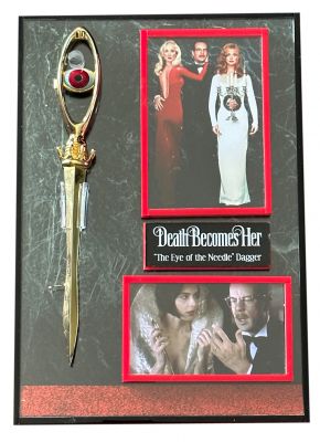 â€œThe Eye of the Needle" Dagger
â€œThe Eye of the Needle" Dagger from Robert Zemeckis' comedy Death Becomes Her. Lisle Von Rhuman (Isabella Rossellini) used her ceremonial dagger to cut both Madeline Ashton (Meryl Streep) and Ernest Menville (Bruce Willis) to drop samples of her age-reversing, immortality potion directly into their blood streams. This rose gold-color metal dagger has a leaf-shaped blade with a pointed tip and a decorative crown detail with droplet-like prongs at the guard. The gold-plated grip is designed to resemble the eye of a sewing needle with a more literal blue and red metal human eye-shaped faux-gemstone installed in the center.
Keywords: â€œThe Eye of the Needle" Dagger
