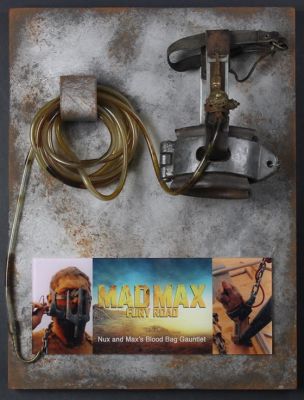 Nux and Max's Blood Bag Gauntlet
In a post-apocalyptic wasteland, a woman rebels against a tyrannical ruler in search for her homeland with the aid of a group of female prisoners, a psychotic worshiper, and a drifter named Max. From the 2015 film Mad Max: Fury Road, this is the hero â€œBlood Bagâ€ used the first half of the film until Max finally tears it off him. You can still see traces of fake special effects blood throughout the tubing from all the usage on screen. Made of leather, metal and plastic tubing; the â€œBlood Bagâ€ is an intravenous cannula used for lengthy blood extractions with a closable tap and hollow needle on the end of the tubing. The particular prop is known for reviving the Leukemia-diagnosed War Boy â€œNuxâ€ and can be scene multiple times in the film beginning with Nux catching Slit taking his steering wheel. He then begs Slit to take him and Max who is acting as Nux's "blood bag", with him so Nux can die in battle earning him a place in Valhalla.
Keywords: Nux and Max's Blood Bag Gauntlet